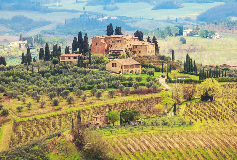 Sunrise over rolling Tuscan hills lined with cypress trees and a countryside villa, Tuscany, Italy